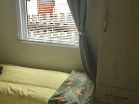 A bedroom with a bed and wardrobe at 38 The Green
