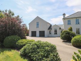 A house with a garage and garden at The East Wing Apartment in Claremorris