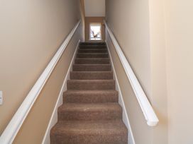 A staircase with carpet and a window at The East Wing Apartment in Claremorris