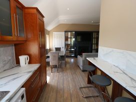 A kitchen with a dining area and a living space at The East Wing Apartment in Claremorris