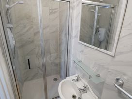 A shower and sink in a bathroom at The East Wing Apartment Claremorris