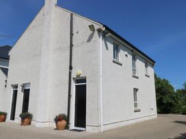 A building with windows and flower pots at The East Wing Apartment Claremorris
