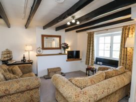 A living room with sofas and a television at Rigg Cottage in Sandsend