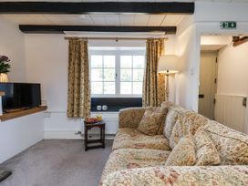 A living room with a sofa and television at Rigg Cottage in Sandsend