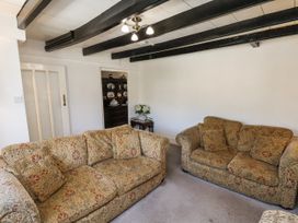 A living room with sofas and a table at Rigg Cottage Sandsend