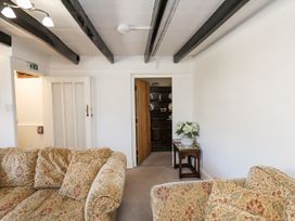 A living room with a sofa and a table at Rigg Cottage in Sandsend