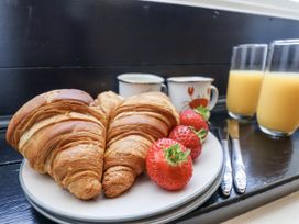 A plate with croissants and strawberries with drinks at Rigg Cottage Sandsend
