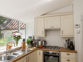 A kitchen with a stove and sink at Rigg Cottage in Sandsend