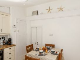 A kitchen with a dining table set for breakfast at Rigg Cottage in Sandsend