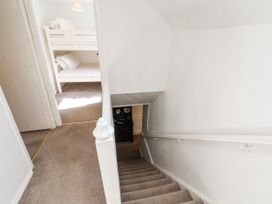 A staircase leading to a hallway with a bunk bed at Rigg Cottage Sandsend