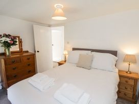 A bedroom with a bed and drawers at Rigg Cottage Sandsend