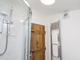 A bathroom with a shower and towel rail at Rigg Cottage in Sandsend