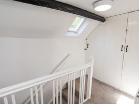 A staircase with a skylight and wardrobe at Rigg Cottage in Sandsend