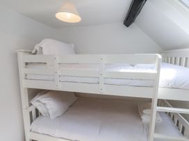 A bunk bed with pillows and sheets at Rigg Cottage Sandsend