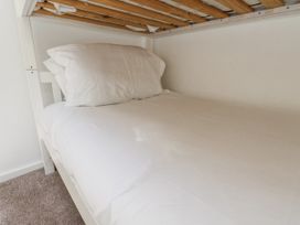 A bunk bed with a mattress and pillow at Rigg Cottage Sandsend