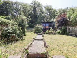 A garden with a path leading to a shed at Rigg Cottage in Sandsend