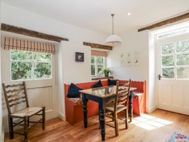 A dining room with a table and chairs at Stable cottage, Sopworth near Sherston
