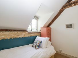 A bedroom with a bed and a window at Stable cottage Sopworth near Sherston