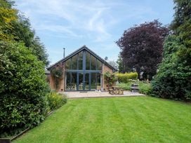 A house with large windows and a patio in the garden at Lawnswood