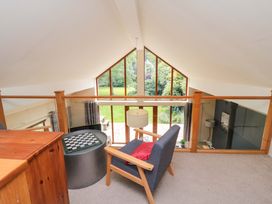 A snug with a chair and table overlooking a garden at Lawnswood