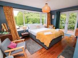 A bedroom with a bed and a chair at Lawnswood