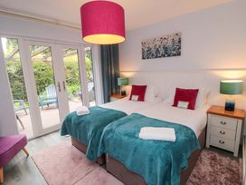 A bedroom with two beds and sliding doors at Lawnswood