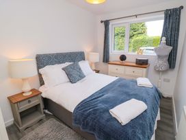 A bedroom with a bed and dresser at Lawnswood