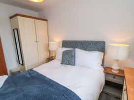 A bedroom with a bed and wardrobe at Lawnswood