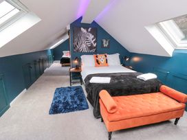 A bedroom with a bed and artwork at Lawnswood