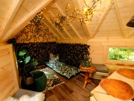 A small indoor space with wooden beams and plants at Lawnswood