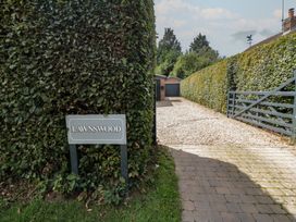 A driveway leading to a building with a sign at Lawnswood in Brompton-by-Sawdon near Sherburn