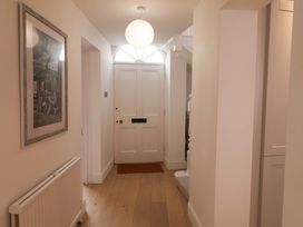 A hallway with a door and a radiator at 11 Ballygate in Babbacombe