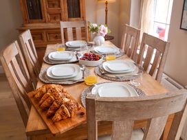 A dining room with a table set for breakfast at 11 Ballygate, Babbacombe