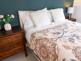 A bedroom with a bed and nightstand at 11 Ballygate in Babbacombe