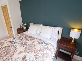 A bedroom with a bed and bedside table at 11 Ballygate in Babbacombe