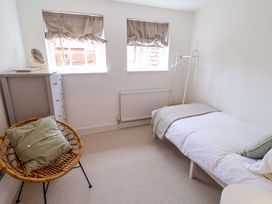 A bedroom with a bed and chair at 11 Ballygate in Babbacombe