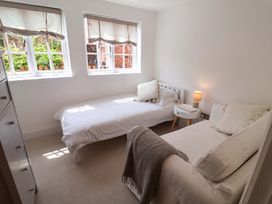 A bedroom with two beds and a nightstand at 11 Ballygate in Babbacombe