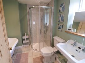 A bathroom with a shower, bathtub, toilet, and sink at 11 Ballygate in Babbacombe