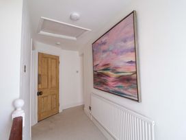 A hallway with a wooden door and large artwork at 11 Ballygate in Babbacombe