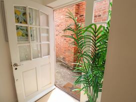 An entrance with a door open to a pathway at 11 Ballygate in Babbacombe