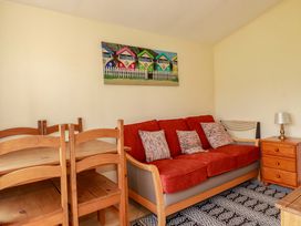 A living room with a sofa and dining table at 101 Atlantic Bays Holiday Park in Padstow