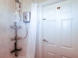 A shower with a shower head and valve in a bathroom at 101 Atlantic Bays Holiday Park in Padstow