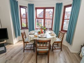 A dining room with a table set for a meal at Flat 9 in Swanage