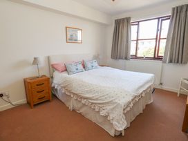 A bedroom with a bed and bedside table at Flat 9 in Swanage