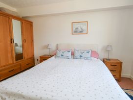 A bedroom with a bed and wardrobe at Flat 9 in Swanage