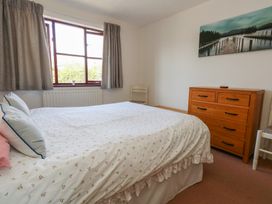 A bedroom with a bed and dresser at Flat 9 in Swanage