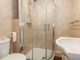 A bathroom with a shower, sink, and toilet at Flat 9 in Swanage