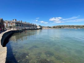 A coastal view with buildings along the shore at Flat 9 Swanage