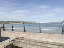 A view of water with boats from a pavement at Flat 9 in Swanage