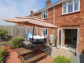 A garden with a hot tub and outdoor seating at 3 Birkbeck Way Norwich
